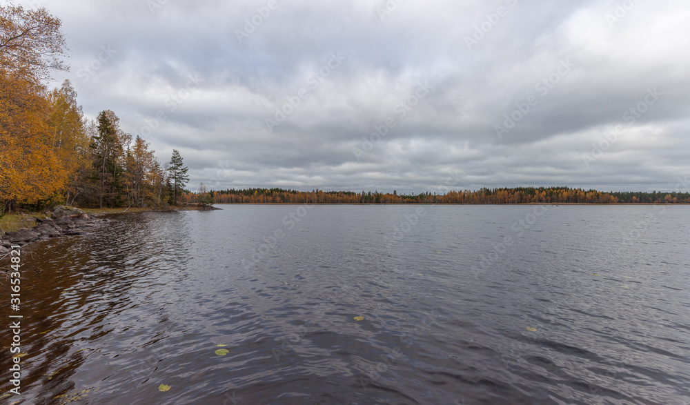 panorama with cloudy sky over pier on the lake. Autumn forest in the background, Sweden, selective focus panorama with cloudy sky over pier on the lake. Autumn forest in the background, Sweden, selective focus