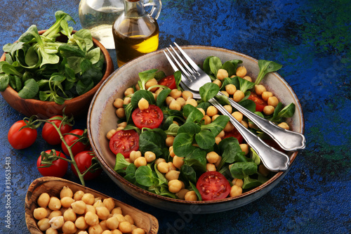 chickpea salad with ingredient and tomatoes and lamb´s lettuce. healthy salad