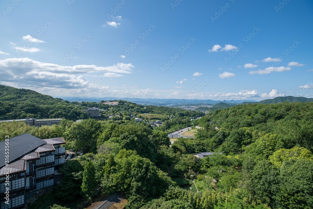 Aerial view of Arima Onsen city with mountains and traditional Japanese buildings