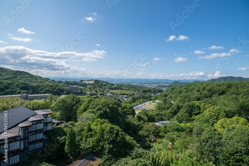 Aerial view of Arima Onsen city with mountains and traditional Japanese buildings © Sen