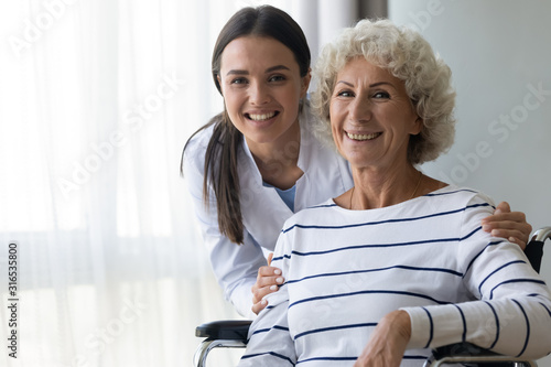 Konstfotografi Head shot portrait smiling caregiver and disabled older woman