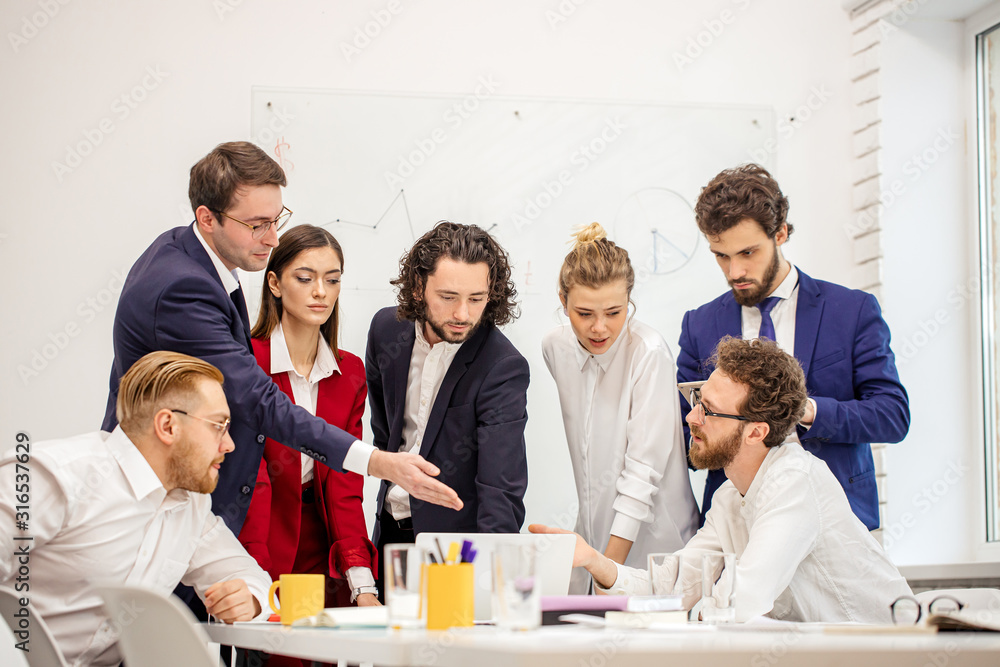best workers of successful busness team gathered in office to discuss new business project, to plan their strategy fot future together