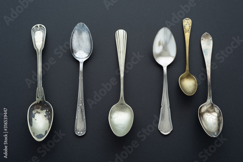 Photography Vintage spoons pattern on black background.
