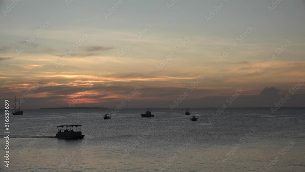 Fishing boats in the Indian Ocean near the coast of the Tanzanian island of Zanzibar. Fishing boats in the Indian Ocean near the coast of the Tanzanian island of Zanzibar.