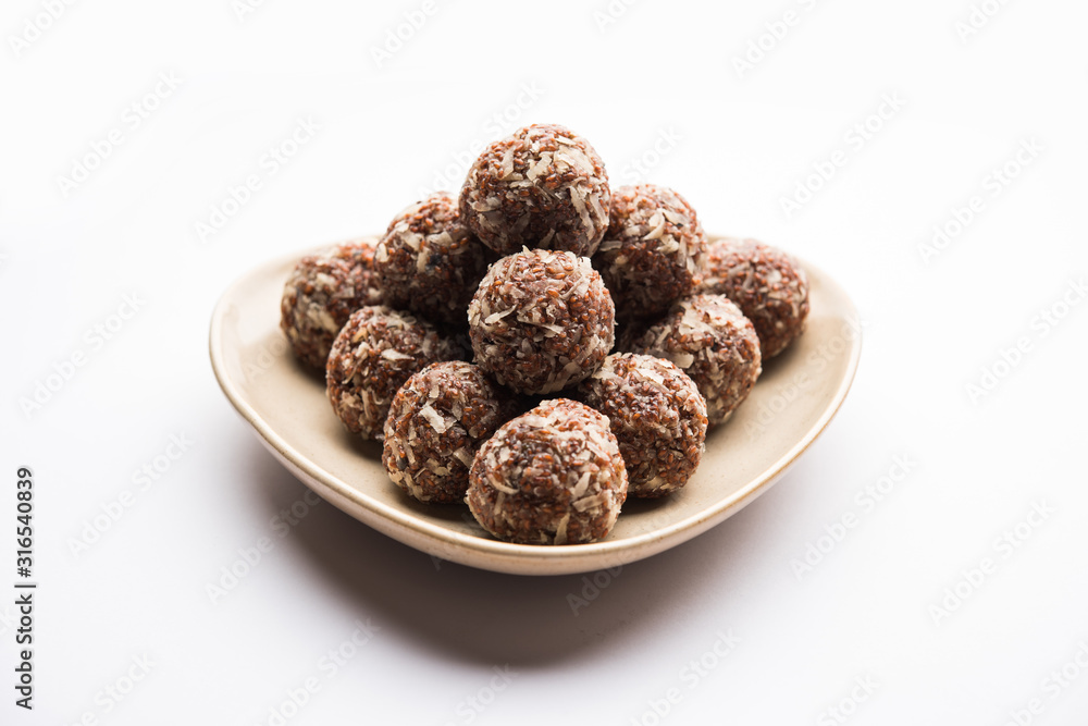Aliv Laddu, Halim Ladoo or Garden cress Seed sweet Balls a very nutritious food in winters or for New Moms. popular food from India. served in a bowl or plate Aliv Laddu, Halim Ladoo or Garden cress Seed sweet Balls a very nutritious food in winters or for New Moms. popular food from India. served in a bowl or plate