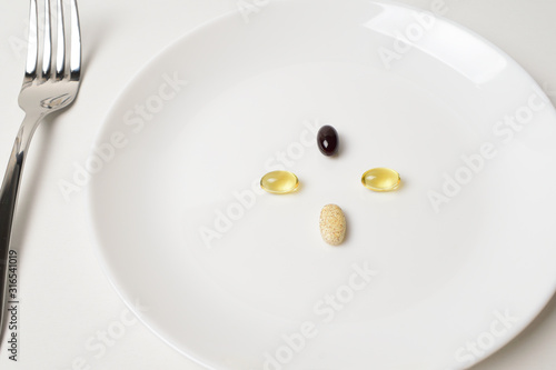 Meal replacement. First person view. Multivitamin and mineral supplements. Table set with tablets.