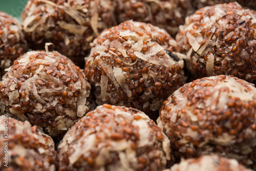 Aliv Laddu, Halim Ladoo or Garden cress Seed sweet Balls a very nutritious food in winters or for New Moms. popular food from India. served in a bowl or plate photo