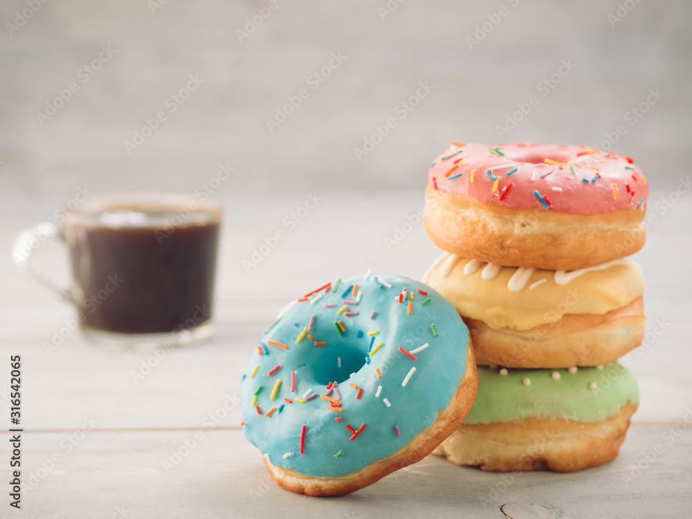 donuts and coffee on blue background , copy space