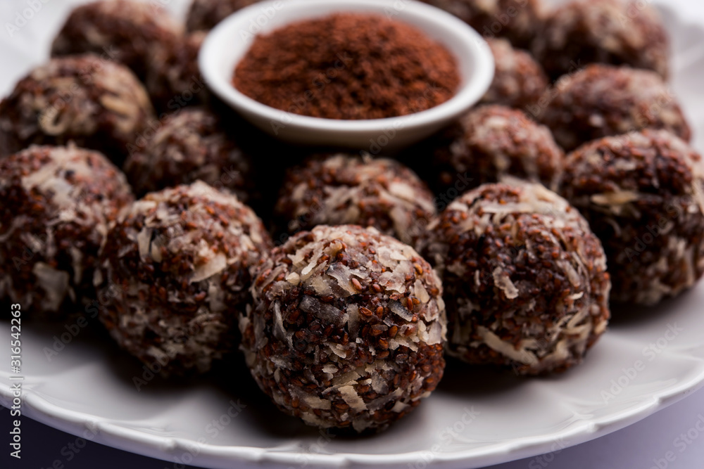 Aliv Laddu, Halim Ladoo or Garden cress Seed sweet Balls a very nutritious food in winters or for New Moms. popular food from India. served in a bowl or plate Aliv Laddu, Halim Ladoo or Garden cress Seed sweet Balls a very nutritious food in winters or for New Moms. popular food from India. served in a bowl or plate
