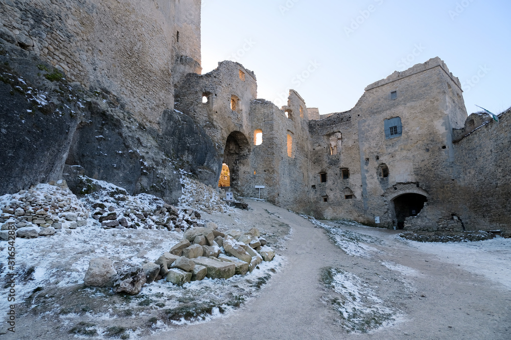 Fototapeta premium Ancient ruined European castle with several empty windows in winter