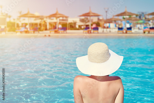 Woman in hat relaxing in swimming pool at the water park. Summer holiday © Lazy_Bear