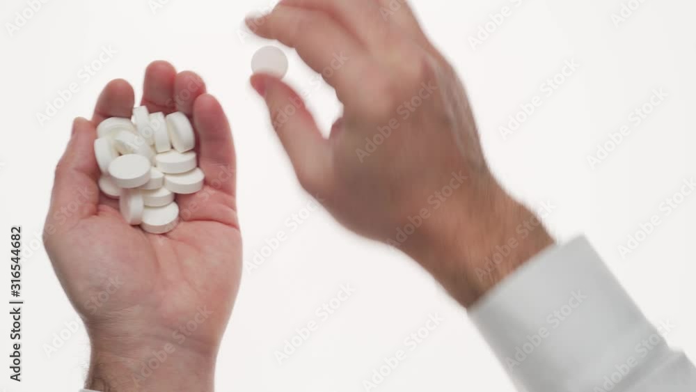 Man hand with pills, tablets, vitamins, drugs, capsules isolated on white background. White shirt, business style. Health care concept. Pharmaceutical industry. Pharmacy. Man hand with pills, tablets, vitamins, drugs, capsules isolated on white background. White shirt, business style. Health care concept. Pharmaceutical industry. Pharmacy.