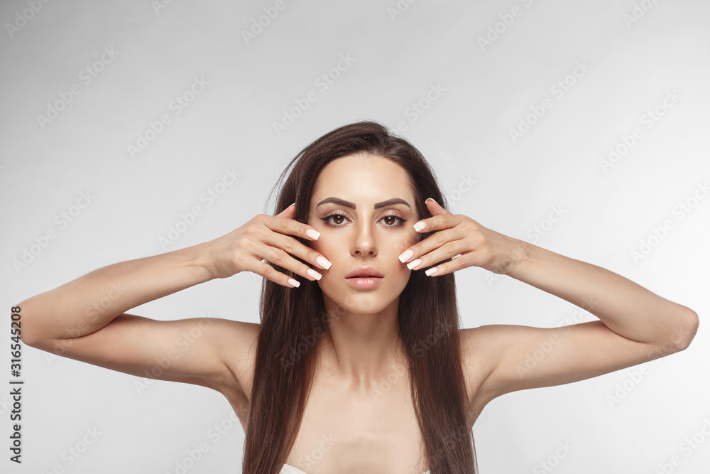 Beautiful woman with a French manicure nail , skin care concept, beautiful skin. Portrait of female hands with manicure nails. Сare for hands and nails and cosmetics Beautiful woman with a French manicure nail , skin care concept, beautiful skin. Portrait of female hands with manicure nails. Сare for hands and nails and cosmetics