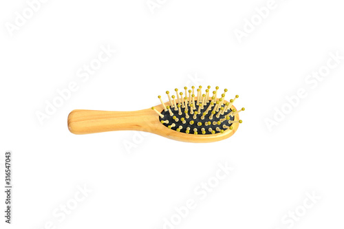 Wooden comb brush isolated on white background.