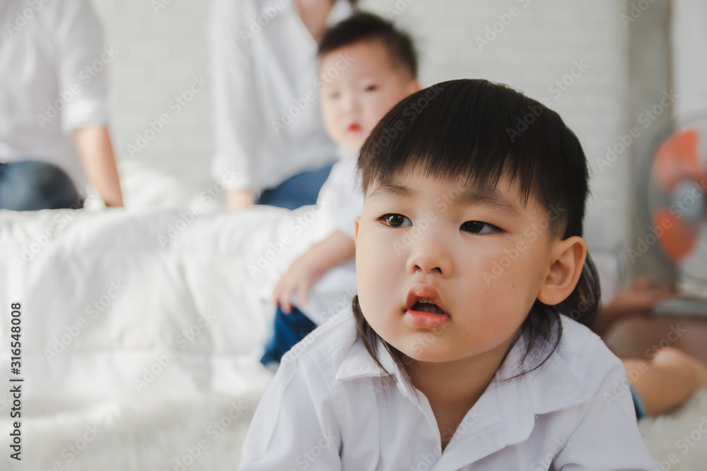 Asian Japanese Family father mother son wearing white shirt carrying child posing for photo on bedroom in white room.To keep memories moment cuteness of son in childhood lifestyle happy Asian Japanese Family father mother son wearing white shirt carrying child posing for photo on bedroom in white room.To keep memories moment cuteness of son in childhood lifestyle happy