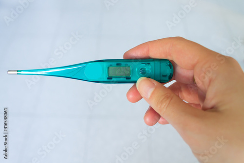 Female hand holding thermometer..Ricorda di aggiungere foto coi gradi celsius! photo