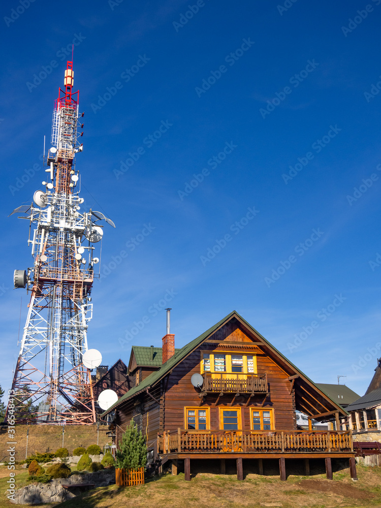 Mountain Hut and Radio Mast on Mountain top Jaworzyna Krynicka at blue sky background, Poland. Mountain Hut and Radio Mast on Mountain top Jaworzyna Krynicka at blue sky background, Poland.