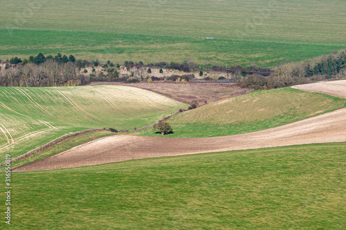 A full frame photograph looking down on a South Downs landscape on a sunny winters day