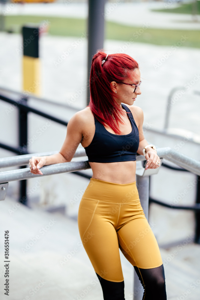 Portrait of sexy redhead athletic woman in sports clothing. Intensive  fitness training and workout.. Stock Photo | Adobe Stock