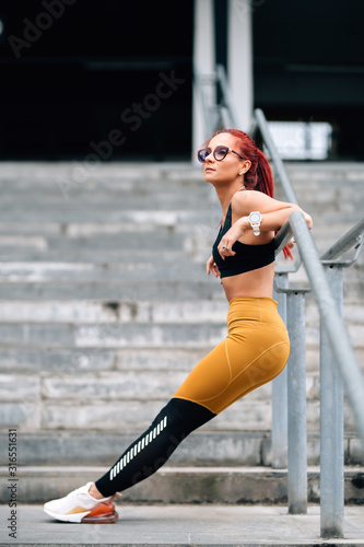 Fototapeta Naklejka Na Ścianę i Meble -  athletic fit woman doing stretching exercises and planks. Gym fitness sport concept