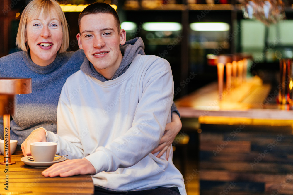 Portrait of grandson and his mother relaxing in cafe,Family Concept. Portrait of grandson and his mother relaxing in cafe,Family Concept.