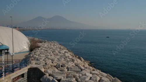 Nápoles. Pescador en barca y Vesubio. Campania, Italia, Europa. photo
