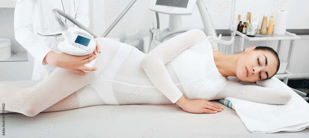 beautiful woman enjoys an LPG massage procedure. Hip cellulite removal beautiful woman enjoys an LPG massage procedure. Hip cellulite removal
