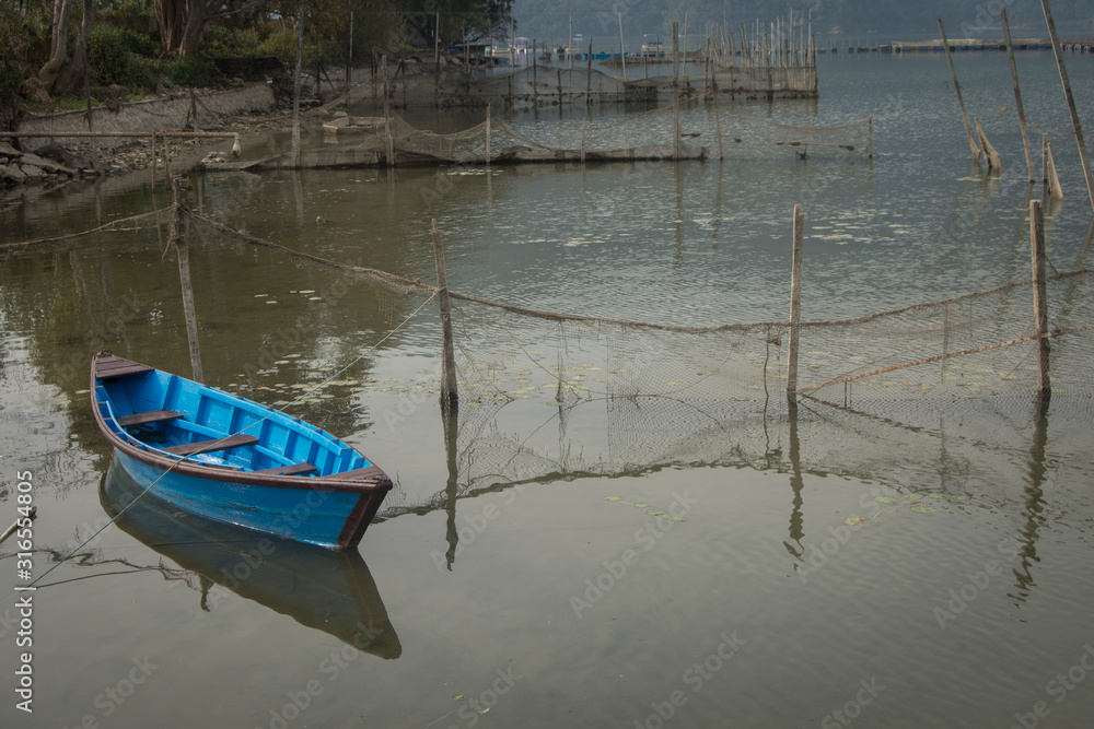 Boats in Phewa Tal lake in Pokhara, Nepal