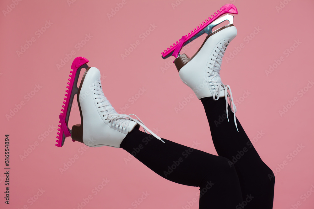 Figure skating is a winter sport and leisure. Slender female legs in