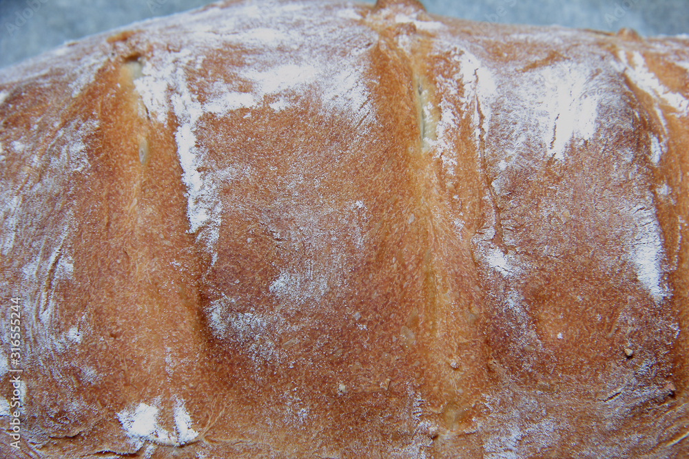 Obraz premium Ready-made food. Home-made bread with a crisp wheat crust.