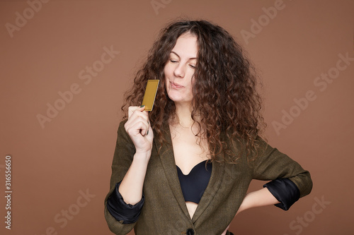 Photography Dreamful foxy fashionable female dressed in black bra and formal jacket being in high spirit about receiving present cart from famous fashionable store, going to make great shopping online, isolated