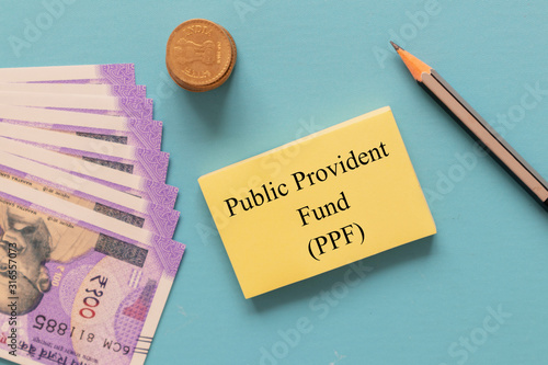 Concept of Investment in public provident fund or PPF with Indian currency notes. photo