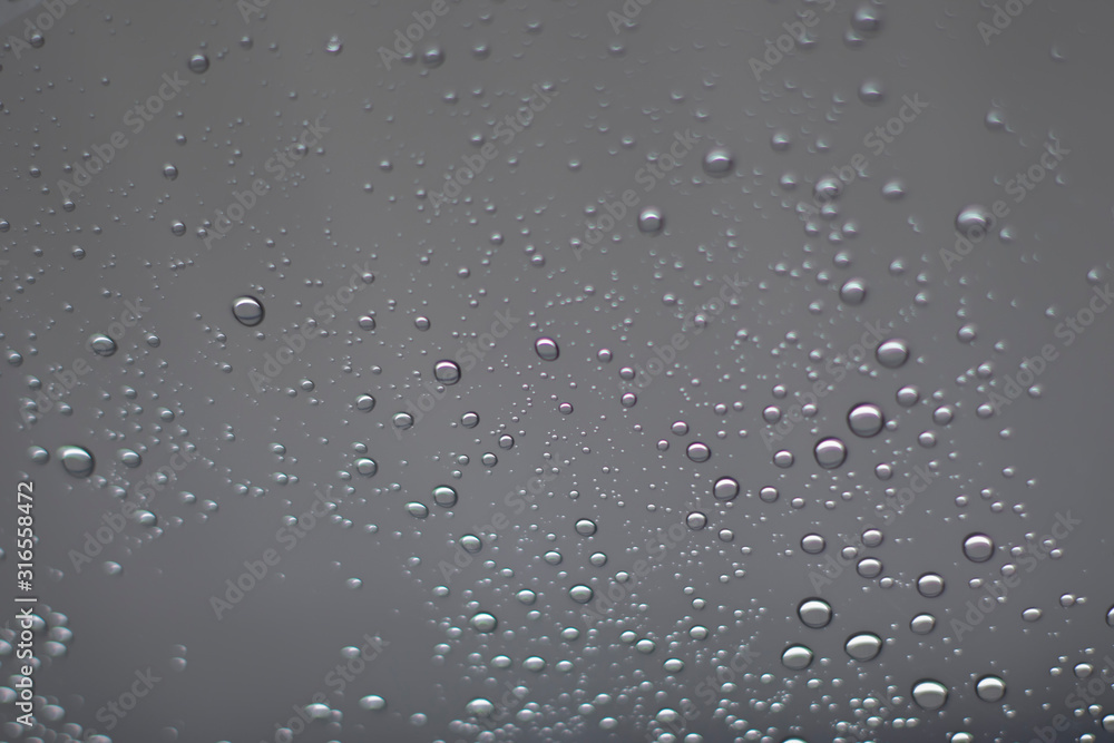Blurred, raindrops, perched on a glass after a rain background image