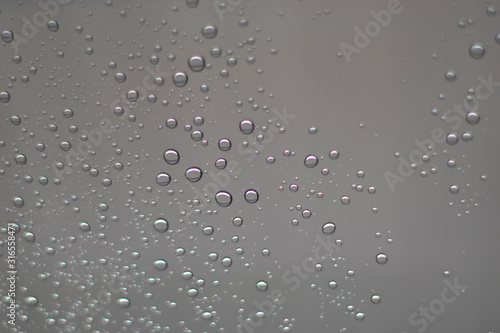 Blurred  raindrops  perched on a glass after a rain background image