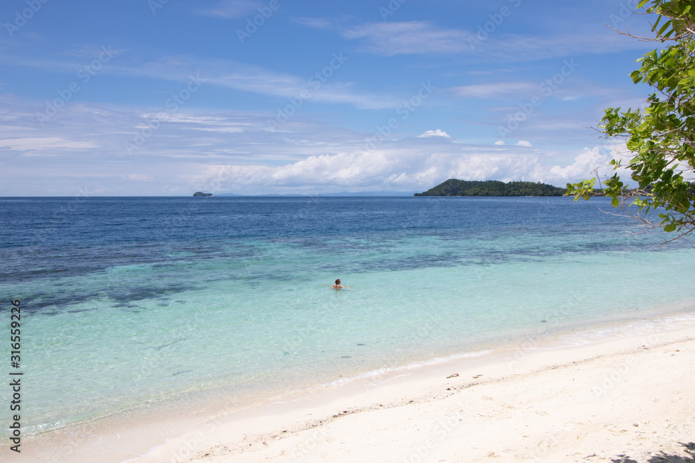 Fototapeta premium woman swimming in a beautiful tropical bay