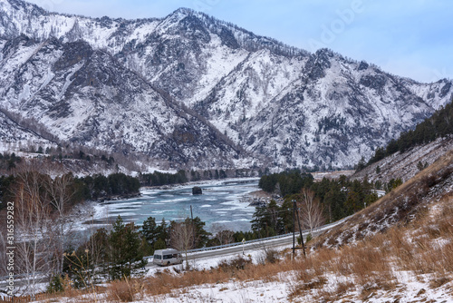 Landscape with snow-capped mountains and mountain river