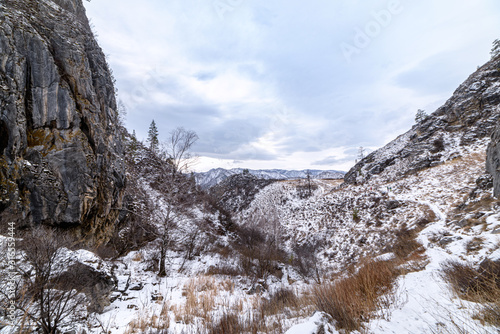 Altai mountain gorge on a winter day, rocks covered with snow
