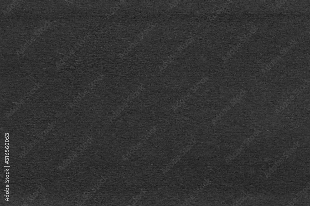 Fototapeta premium Cardboard black abstract texture close-up. Dark old paper background. Grunge concrete wall. Vintage blank wallpaper.