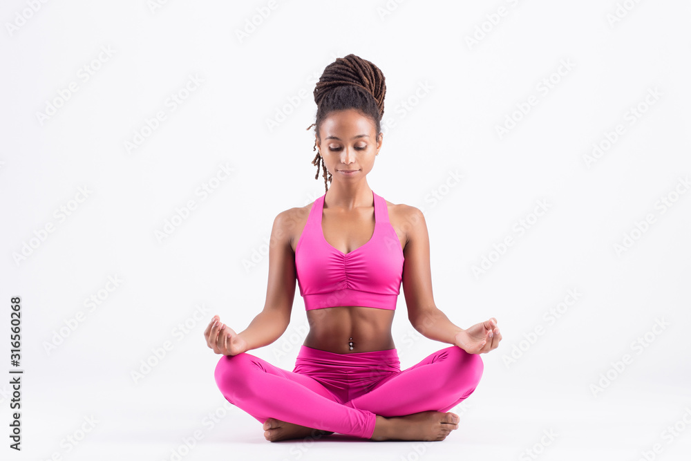 Pretty young black woman doing yoga exercise isolated on white background