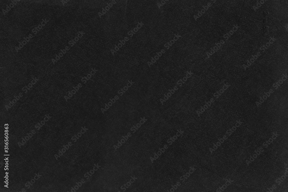 Cardboard black abstract texture close-up. Dark old paper background. Grunge concrete wall. Vintage blank wallpaper.