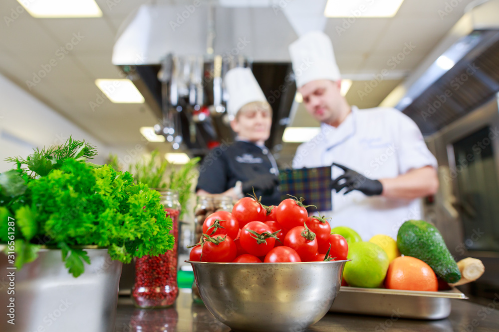 cook preparing dinner in a restaurant kitchen. cook preparing dinner in a restaurant kitchen.