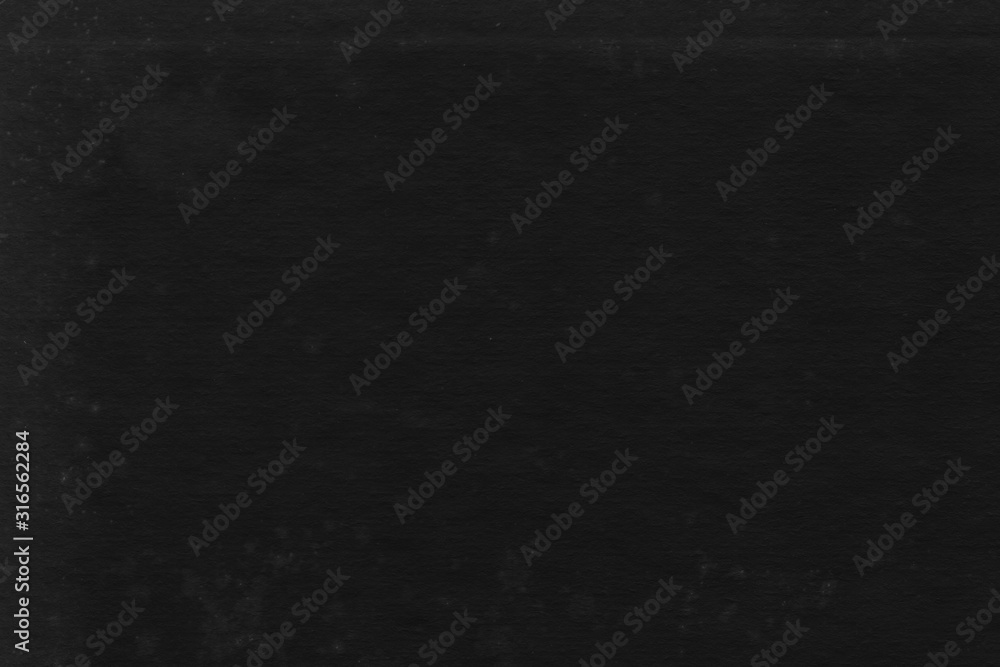 Fototapeta premium Cardboard black abstract texture close-up. Dark old paper background. Grunge concrete wall. Vintage blank wallpaper.