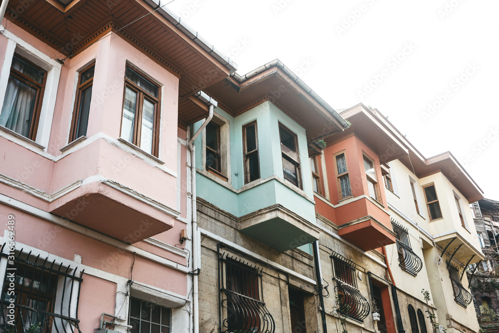 Fototapeta premium Ancient traditional apartment buildings in the Balat district of Istanbul in Turkey. The houses in this area were built in the 15-18 centuries, not later.