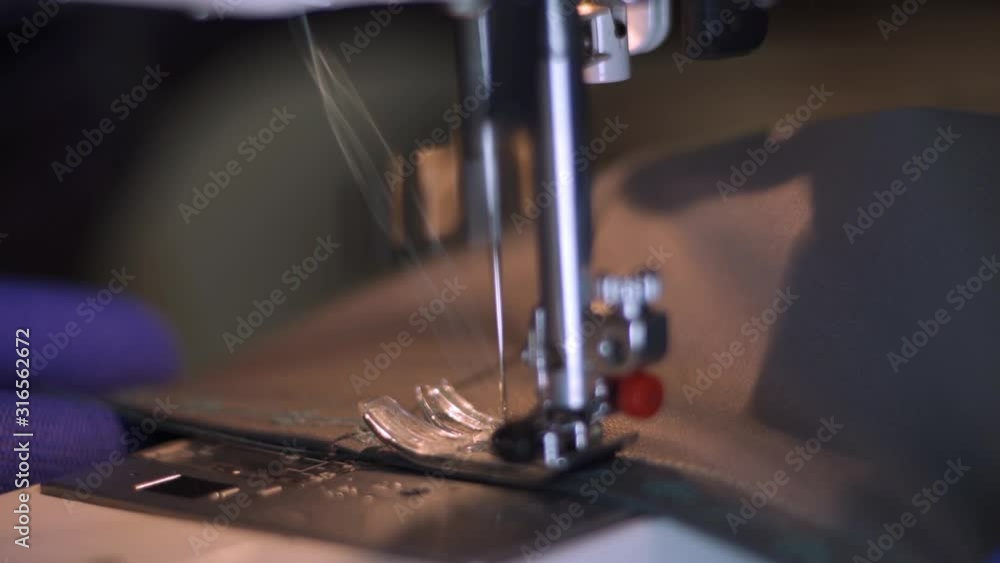 Close-up of sewing machine needle rapidly moves up and down. Close-up of sewing machine needle rapidly moves up and down.