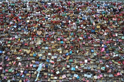 Love locks at the Hohenzollern Bridge in Cologne. Couples symbolize their love by locking a padlock on bridge and throwing the key into the Rhine river.
