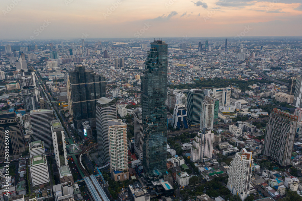 Fototapeta premium beautiful city view at twilight scene City scape of MahaNakhon building, skyscraper in the Silom/Sathon central business district of Bangkok as the tallest building in Thailand