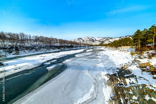 Landscape with snow-capped mountains and mountain river