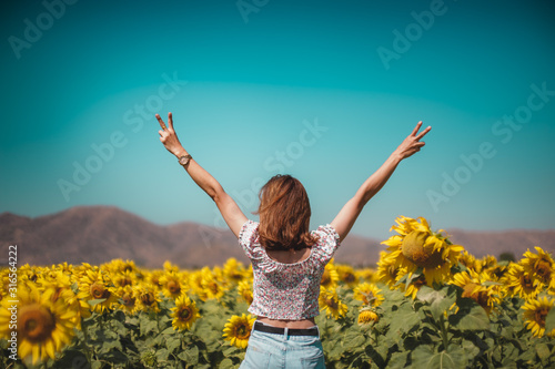 Backside of beautiful woman raise both arms up in the air ,Loves freedom and likes to travel beautiful nature.Concept of happy living with nature.