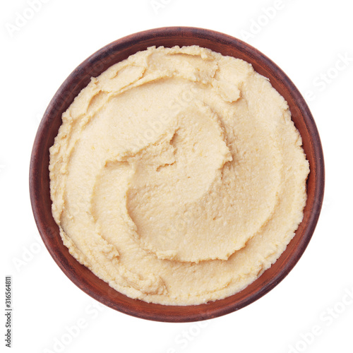 Flat lay view at hummus - spread made from cooked, mashed chickpeas blended with tahini, lemon juice, and garlic isolated on white background. Clipping path added