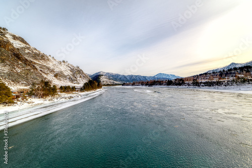Landscape with snow-capped mountains and mountain river